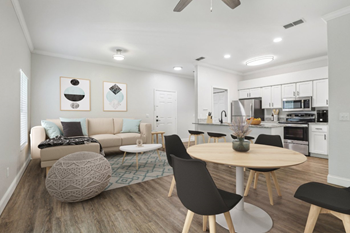 A modern living room with a round table and chairs.